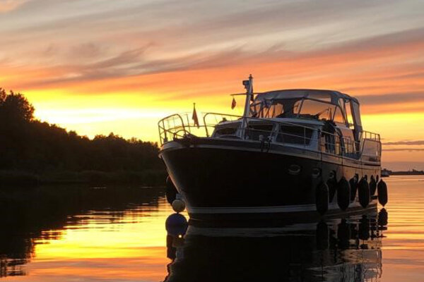 Motorboot in schaduw van avondzon op Friese Meren 